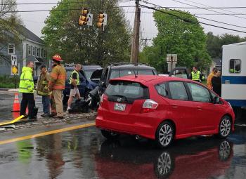 Rockport's new fire chief, Jason Peasley, far left in yellow, spends day two helping tend to Tuesday's accident at routes 17 and 90. (Photo by Lynda Clancy)