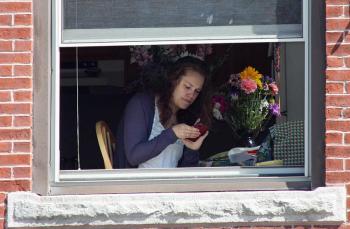 A tenant above Camden Custom Embroidery has a unique vantage point of Monday's Memorial Day parade. (Photo by Holly S. Edwards)