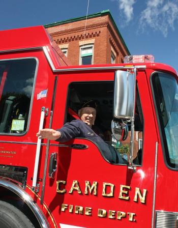 Camden dedicated the 2013 Town Report to longtime Camden Fire Department member Harold Drinkwater, who rode in his namesake, Engine 4, during the parade. (Photo by Holly S. Edwards)