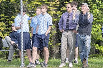 Oceanside players, coach and fans watch the No. 1 singles match. (Photo Courtesy of Dwight Pitcairn)