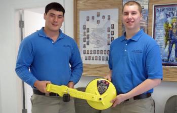 From left, Travis Spencer and Lewis Dyer provide parking enforcement in Belfast and their newest tool is a vehicle disabling device, which will be employed beginning in July to nab car owners with overdue parking tickets and force them to pay up. (Photo by Erica Thoms)