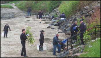 Volunteers, including members of the Rockland Fire Department, work at Sandy Beach to collect trash and clear brush and weeds. (Photos by Chris Wolf)