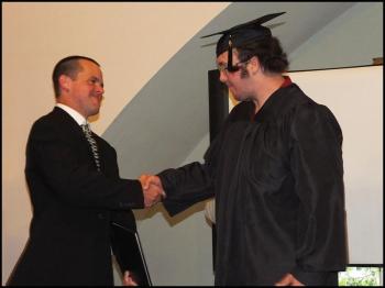 Steven Neill Mackenzie, Community School graduate, receives his degree from Joseph Hufnagel in a ceremony at High Mountain Hall, Friday evening. (Photos by Chris Wolf)