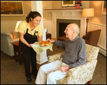 Sarah Bryant (housekeeping and dietary) serves Bartlett Woods resident Richard Neville during the open house on Saturday. "I've been here two weeks," he said. "So far it's been wonderful." (Photos by Chris Wolf)