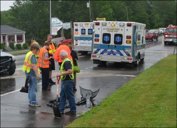 Debris from the crash is cleaned up by Rockport firefighters. (Photo by Lynda Clancy)