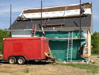 A crew from Heartwood Carpentry puts shingles on the roof of the new Lincolnville Community Library. (Photo by Sheila Polson)