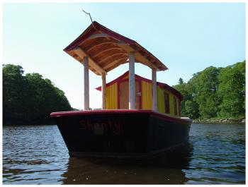 A canopy on over the open afterdeck of "Shanty" includes a stick from which Haslett hopes a kingfisher might want to perch for a better view to the water. (Photo by Ethan Andrews)