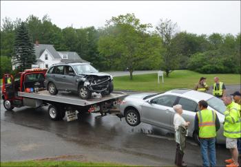 Both cars are hauled up the road to Camden. (Photo by Lynda Clancy)