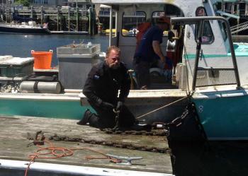 Lobsterman and diver Toby Wincklhofer at work on a float in Camden Harbor. (Photo by Steve Pixley)