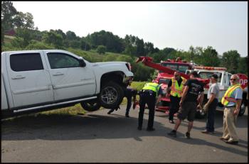 Rockport Fire Department, Rockport police, Camden First Aid and Camden Exxon responded to a single-vehicle crash on Main Street in Rockport Monday morning. The truck was totaled with heavy damage to its front end and engine, according to police. (Photo by Lynda Clancy)
