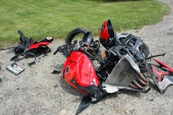 Broken in half, various bits and pieces of the Vernon Kvorjak's Suzuki GSXR600 lay alongside Mill Street in Rockport June 10. (Photo by Holly S. Edwards)