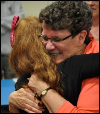 Carol Hathorne hugging a student, saying goodbye.