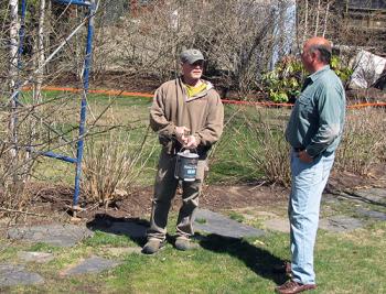 Boucher discusses painting on a house he cares for with Lincolnville painter John Kelly. (Photo by Tom Groening)