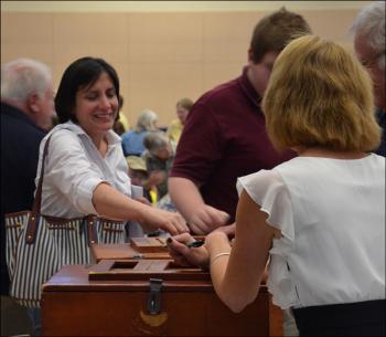 Lincolnville resident MaryAnne Mercier casts her ballot into the box.