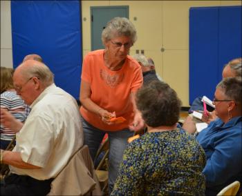 Margaret Morse, Hope election clerk, hands paper ballots to voters. (Photo by Lynda Clancy)