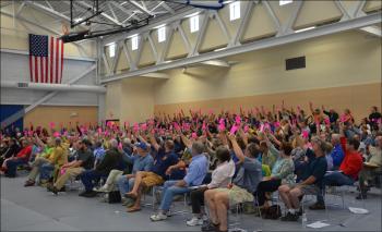 Raising their cards, casting their votes. (Lynda Clancy)