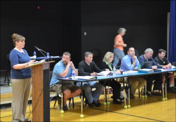 Tax Collector Rosanna Bowman reports to townspeople the results of the June 11 poll questions. To her left: Selectmen Jason Hall, Brian Powers Jr., Wendy Pelletier, Town Administrator Jon Duke, and selectmen Eric Campbell and Tim Pearse. (Photo by Lynda Clancy)