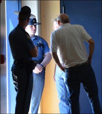 About halfway through the meeting, two state troopers stopped by to assess progress. (Photo by Lynda Clancy)