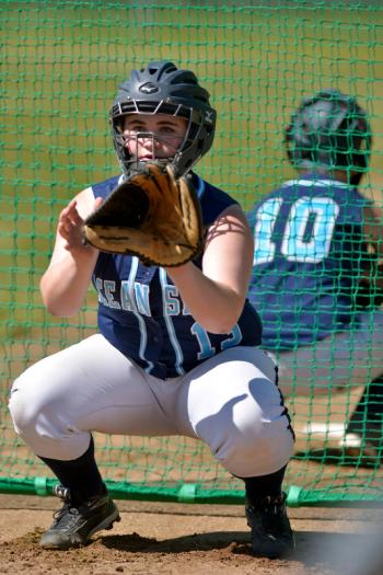 What looks like a mirror image it is actually, Kalyn Grover with Ari Curtis behind her catching another pitcher warming up. (Photo by Ron Hawkes)