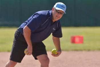 Oceanside assistant coach John Frye ducks out of the way of a ball in his direction during warm ups. (Photo by Ron Hawkes)