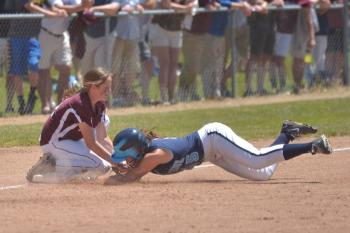Oceanside's Hannah Plourde makes a head first slide into third base as she is caught stealing by Greely's Elyse Dinan. (Photo by Ron Hawkes)