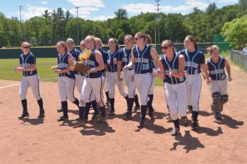 After taking the gold glove to show the fans the girls return for their awards. (Photo by Ron Hawkes)