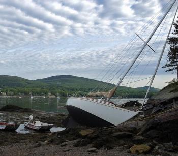 Camden Harbormaster Steve Pixley's whaler floats next to the 30-foot sailboat 'Providence' Thursday morning, which is when it was found beached on the one spit of sandy beach on Curtis Island in the outer harbor. (Courtesy Steve Pixley)