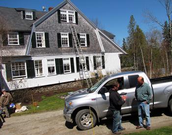 Mike Boucher, right, speaks with Andy Staples, one of the contractors who works on houses Boucher cares for on Islesboro. (Photo courtesy of Tom Groening, Island Institute)