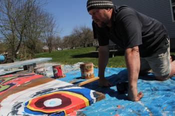 Eric Leppanen, with paints, outside his home in Belfast. (Photo by Wes Sterrs)