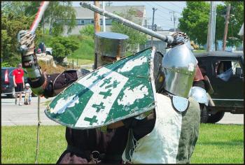 Nathaniel Lysander, of Waldoboro (dark knight,) and Cedric of Thanet, from China, demonstrate fighting techniques Saturday in Harbor Park. (Photos by Chris Wolf)