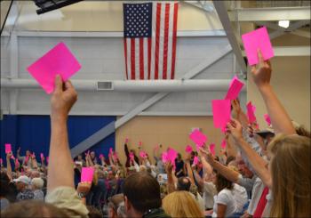 Lincolnville citizens use hot pink cards Saturday to indicate whether they wanted to keep its police department intact for $85,557. Ultimately, opposition to a local police force prevailed and the police chief's job eliminated. Police Chief Ron Young will remain on the job until the end of this month, per his contract. (Photo by Lynda Clancy)