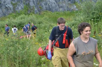 Alisha Penn walks up and out of the quarry area with the help of Rockland and Thomaston firefighters. (Photo by Lynda Clancy)