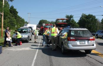 North East Mobile Health crewmembers talk to Jean Curtin, left, after she crashed her car into the back of a pickup truck on Route 17 in Rockport Wednesday morning. (Photo by Holly S. Edwards)