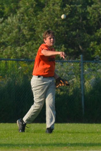 Rockland's Josh Peaco returns the ball from left field after a single from Waldoboro. (Photo by Ron Hawkes)