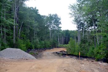 The PITCH will be set far off the road around this corner and quite a distance back into the area of the project. The entire building will not be seen from the road. (Photo by Ron Hawkes)