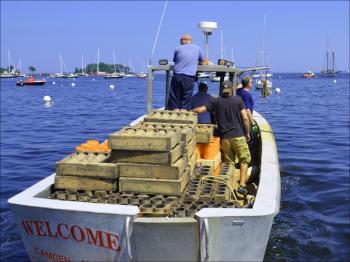 The Welcome, loaded with fireworks, heads out into Camden Harbor. (Photo by Lynda Clancy)