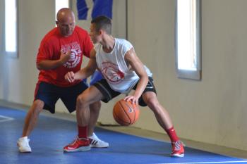 The Basketball House owner, Mike Woodbury, left, works with a player on getting by your defender and getting to the paint or as Woody calls it "the scoring lane". (Photo by Ron Hawkes)