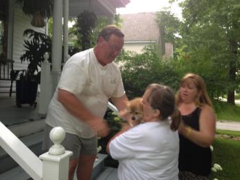 Frank Long, of Camden, hands Skippy to his owner, Jeanette Frost, of Warren. Her daughter, Denise Leary, stands beside her. (Photo by Lynda Clancy)