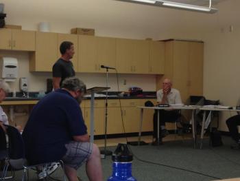 Lincolnville resident Adam Chalmers addresses the Lincolnville selectmen, saying fireworks need no further municipal regulation. Seated is Donnie Heald IV. (Photo by Lynda Clancy)