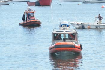 U.S. Coast Guard, Rockland Police Department and Rockland Harbor boats search the city's inner harbor for a missing diver Sunday afternoon. (Photo by Ron Hawkes)
