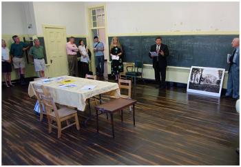 “I normally feel compelled to say, ‘Good morning ladies and gentlemen,’ but I have an urge to say, ‘Good morning class,’” said auctioneer Stefan Keenan at Wednesday’s sale of the former Peirce Elementary School. (Photo by Ethan Andrews)