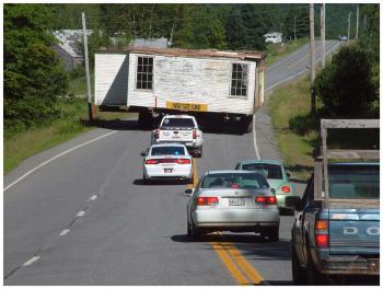 The old school house slowed traffic in both directions on Route 137 Monday morning during the move. (Photo by Ethan Andrews)