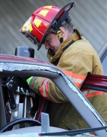 Rockport Fire Lt. Bill Lane operates Lincolnville's Hurst hydraulic spreader. (Photo by Holly S. Edwards)