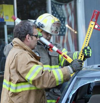 Steve Laite and Lincolnville Asst. Fire Chief Peter Rollins work with a hand-cranked spreader. (Photo by Holly S. Edwards)