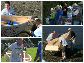 Volunteers and builders move the finished boats to the water’s edge.