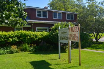 WE have moved! Three word the library staff and board of directors were happy to be able to say. (Photo by Ron Hawkes)