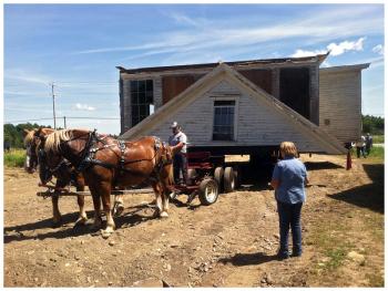 Knox Historical Society President Clayton Larrabee pulled the school house for the last half mile with a team of two Belgian draft horses. (Photo by Ethan Andrews)