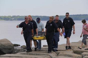 A typical rescue off the Rockland breakwater can require as many as six individuals carrying the patient in a litter and crossing over the same uneven granite blocks that tripped up the patient. (Courtesy Rockland Fire Dept./by Alan Athearn)