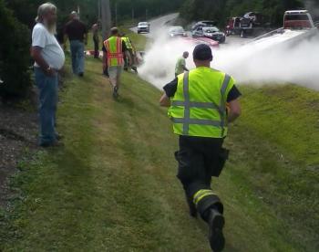 Waldoboro firefighters respond to an accident on Route 1 in Waldoboro, where a Toyota sedan caught fire. (Photo by Mike Scarborough)