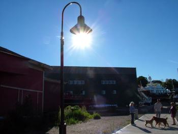 Overspill from new light fixtures along the Harbor Walk has caused concern among some nearby residents. Members of the City Council are considering a group visit to the path at night to see for themselves. (Photo by Ethan Andrews)